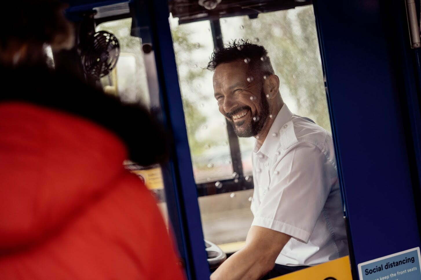Bus driver smiling at passenger