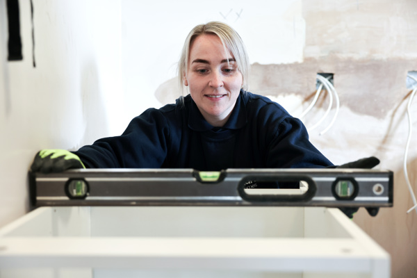 Woman using a spirit level.